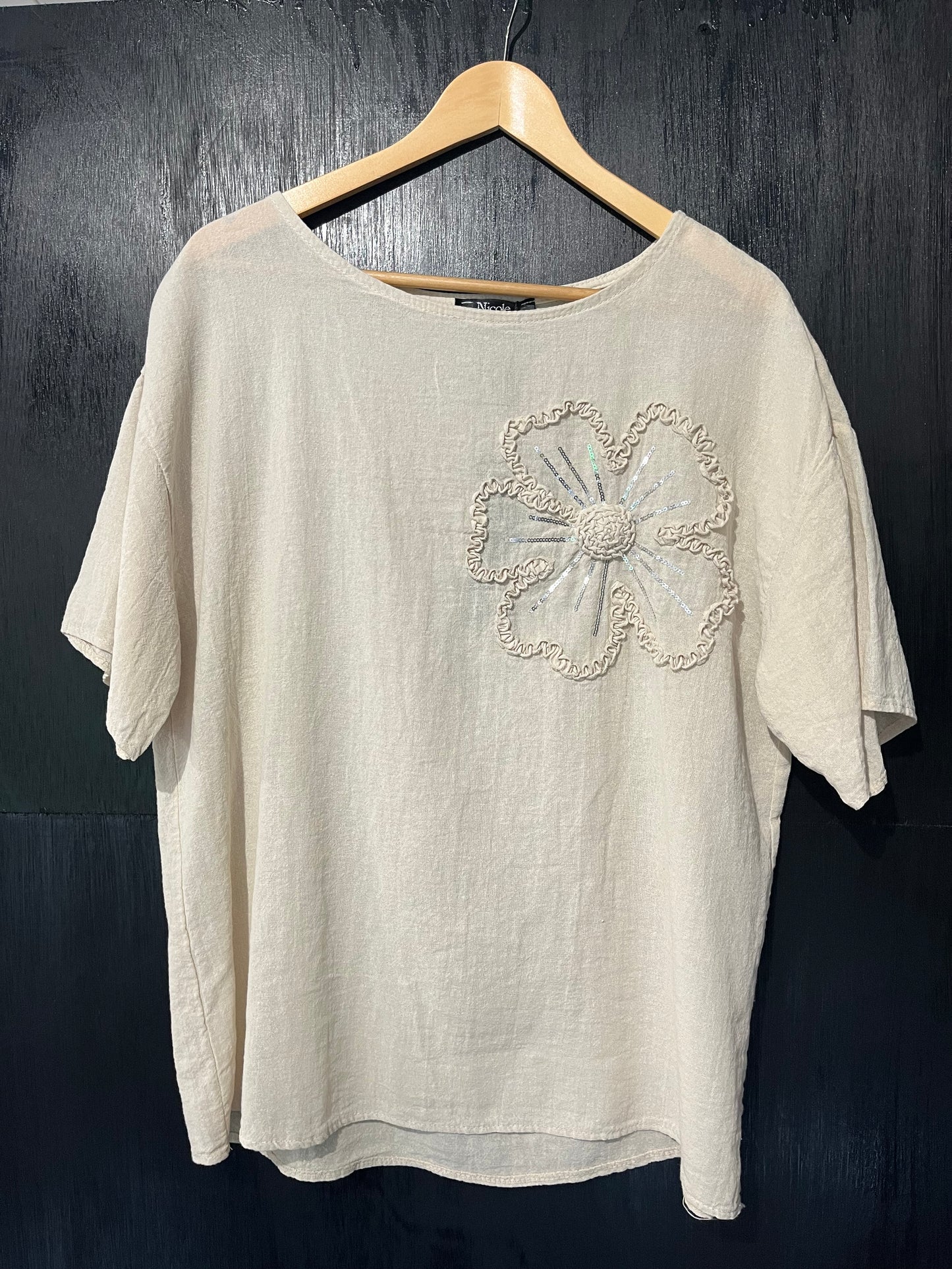 natural cotton top with a sequined floral embellishment
