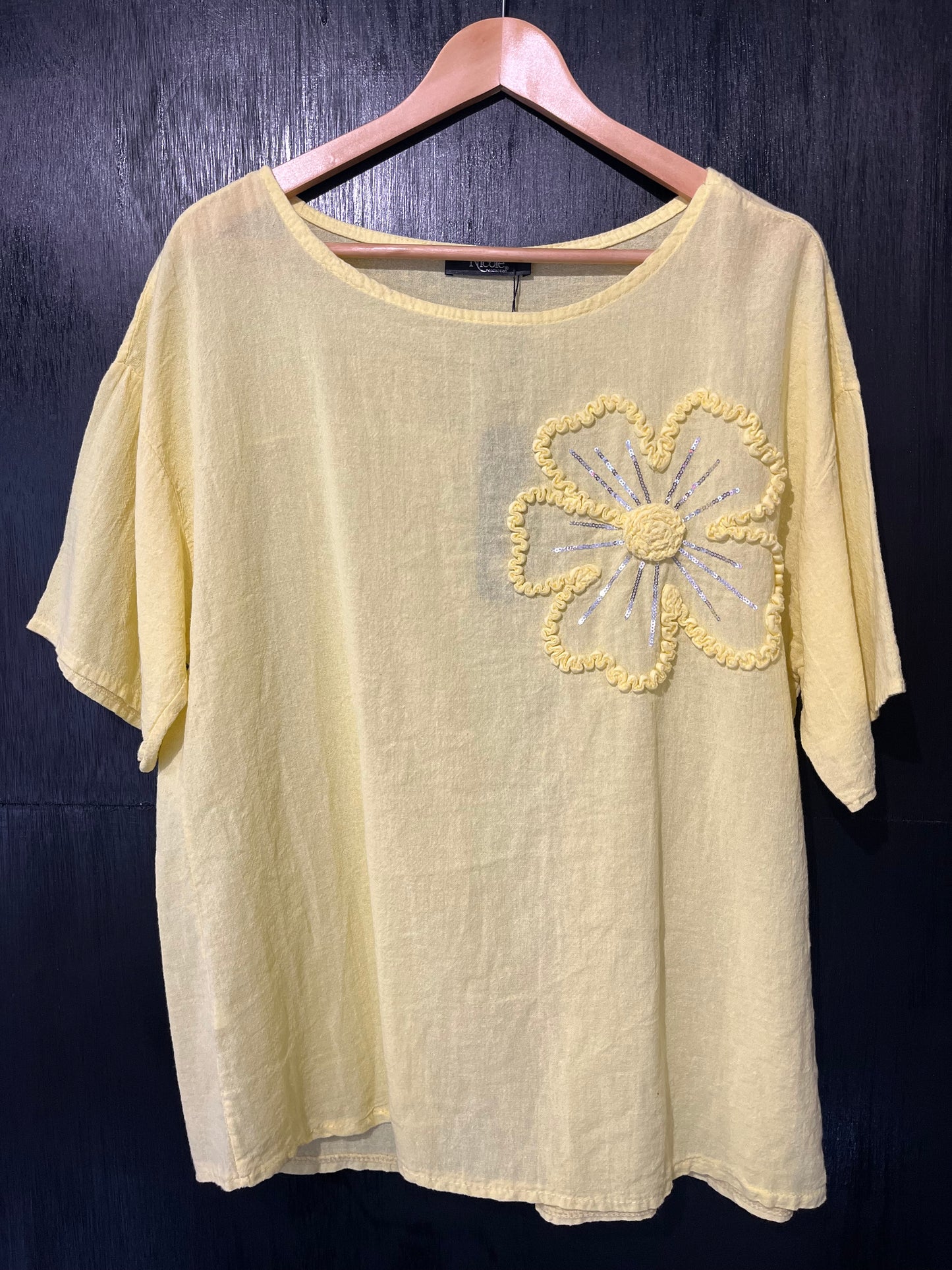 natural cotton top with a sequined floral embellishment