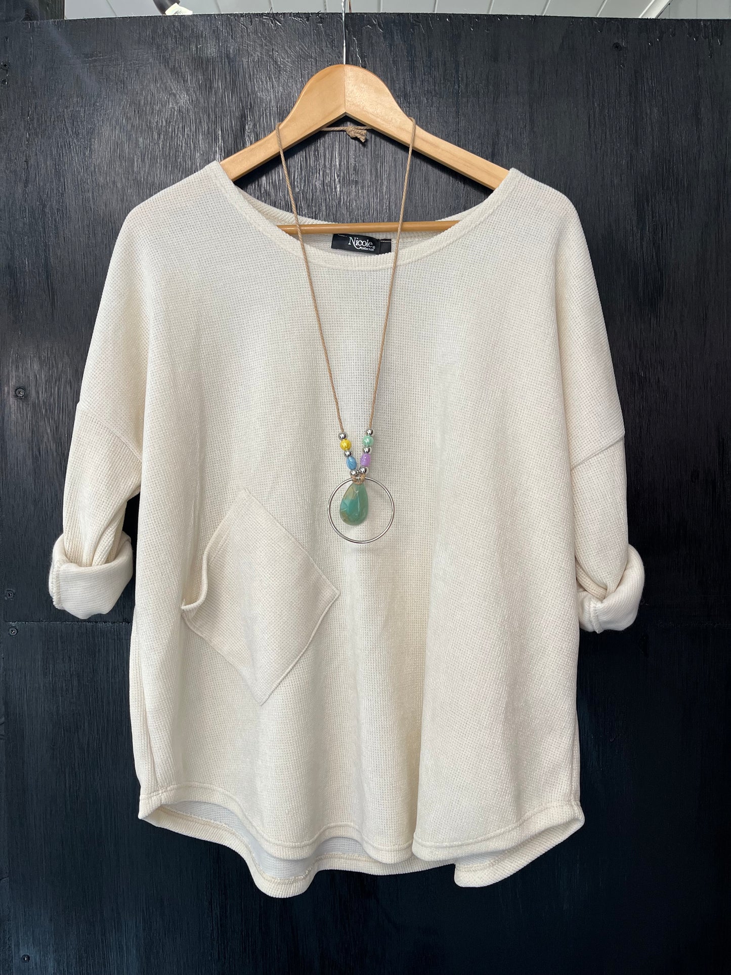 heavy cord style fabric long sleeve jumper with pocket detail and necklace