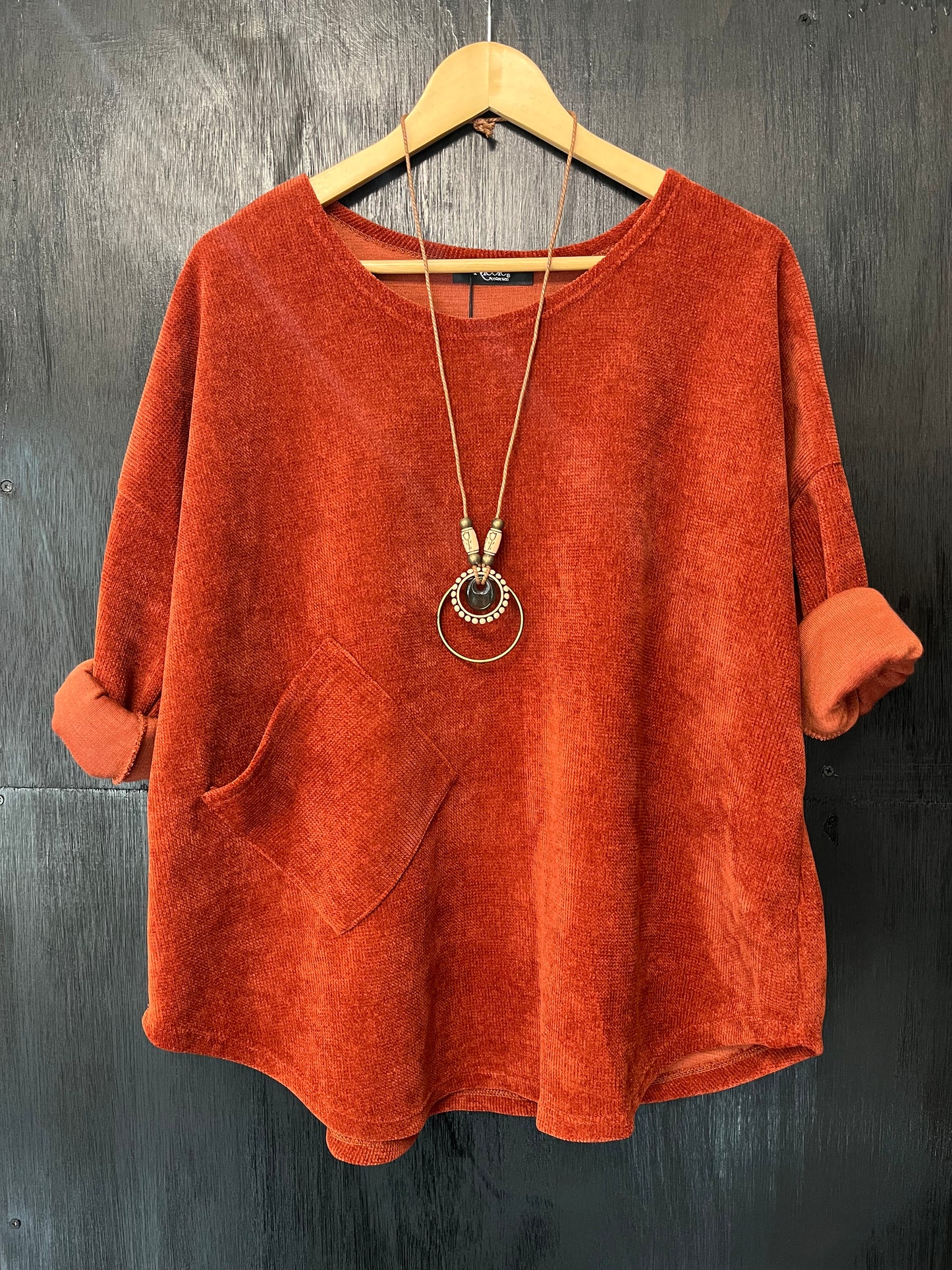 heavy cord style fabric long sleeve jumper with pocket detail and necklace