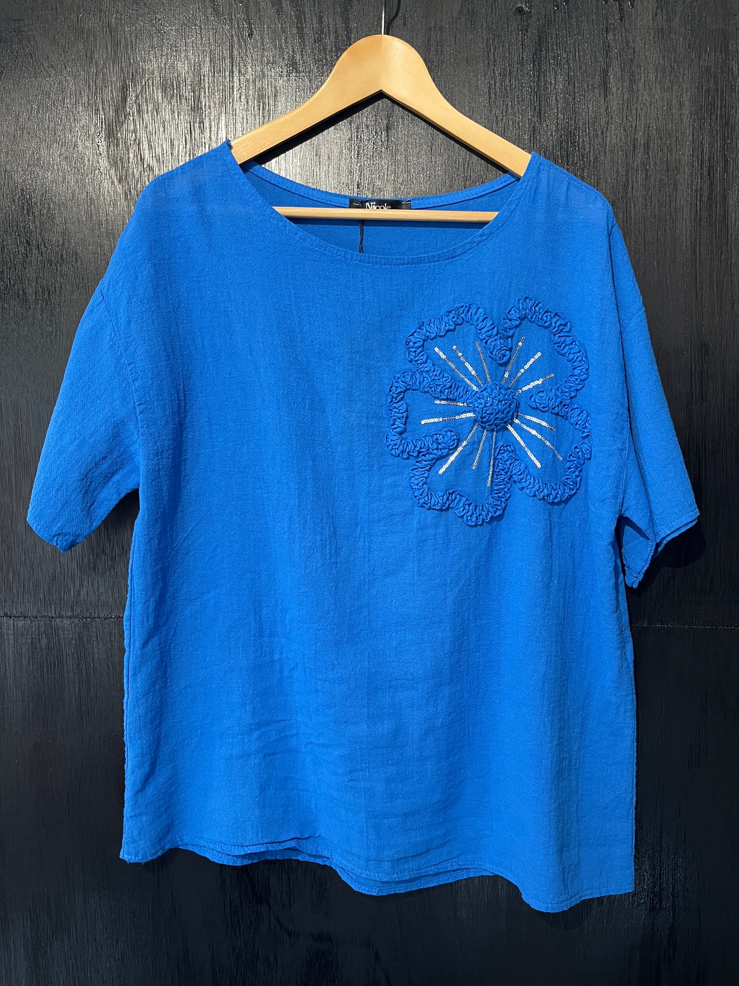natural cotton top with a sequined floral embellishment