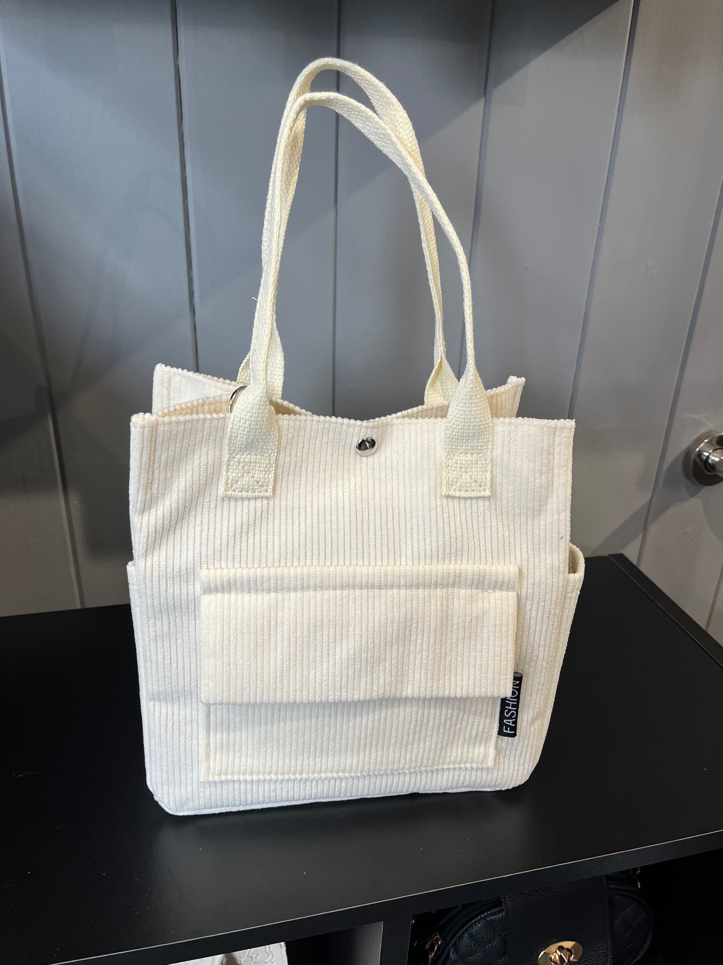 Cord handbag with front and side pocket