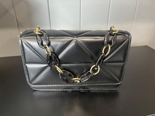 Black quilted faux leather crossbody bag with a chain strap