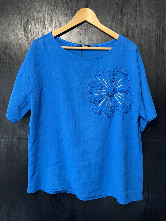 natural cotton top with a sequined floral embellishment